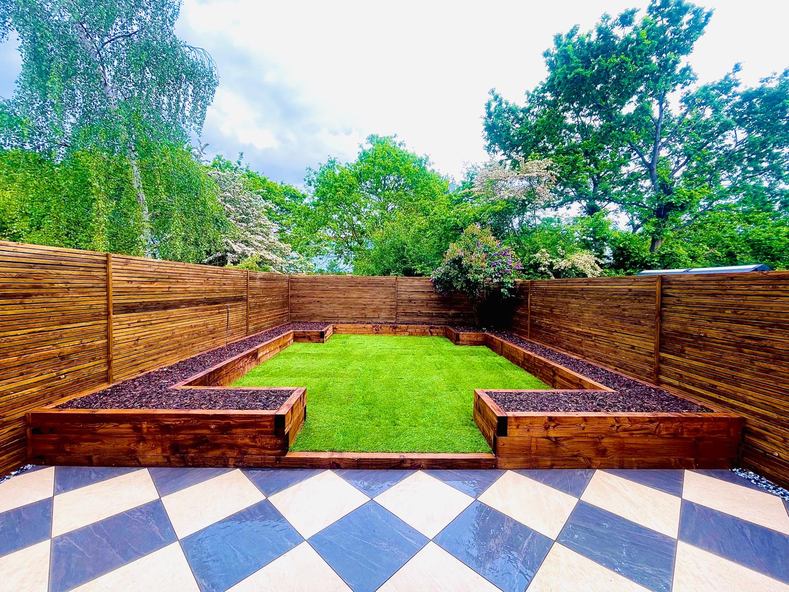 After landscaping work showing a completed garden transformation with lawn and raised timber beds