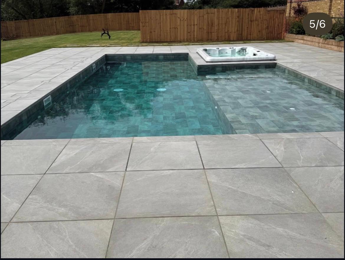 Swimming pool with hot tub and stone surround